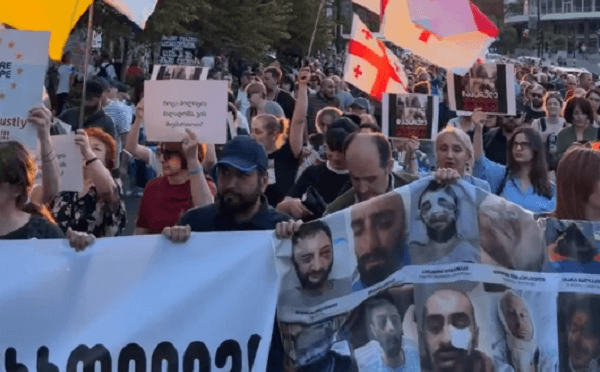 აქციის მონაწილეები ბანერებით ფილარმონიის წინ